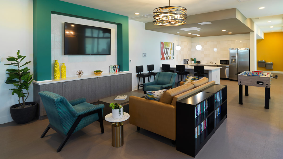 TV seating area and kitchen area in community room at Veterans Park in Pomona, California