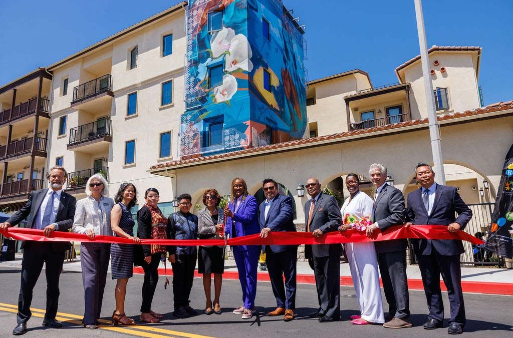 Government officials and developer executives perform the ceremonial ribbon cutting at Fairview Heights apartments